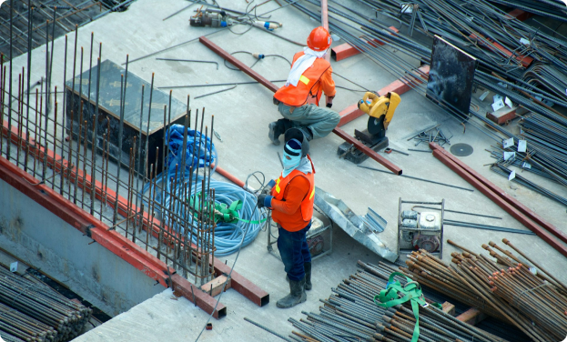 Construction workers on site with various equipment and materials